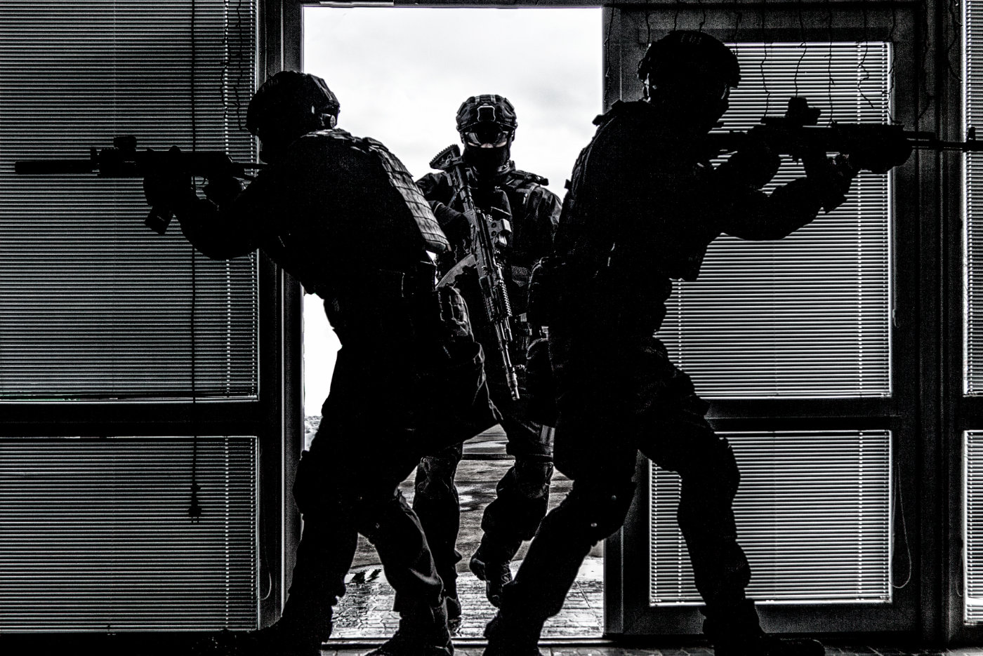 SWAT team breaching door and storming apartments